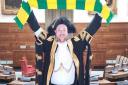 Lord mayor Martin Schmierer holds a Norwich City scarf aloft in the council chamber. Picture: Courtesy of Martin Schmierer