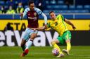Dwight McNeil of Burnley and Kenny McLean of Norwich in action during the Premier League match at Turf Moor