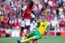 Norwich City's on loan Manchester United full back Brandon Williams snaps into a tackle on Arsenal's Nicolas Pepe.