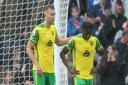 Ben Gibson and Bali Mumba of Norwich look dejected after their side concedes its fourth goal during the Premier League match at the Etihad Stadium, Manchester
