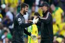 Liverpool manager Jurgen Klopp celebrates a 3-0 Premier League win at Norwich City with keeper Alisson