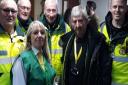 Norwich City fan Paul Mills, with club staff and paramedics who saved his life. Picture: Courtesy of Paul Mills