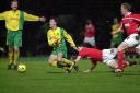 Norwich City's Chris Llewellyn goes down after a challenge from Barnsley's Chris Morgan with Iwan Roberts appealing the tackle in the background. Date: January 8, 2000.