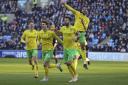 Norwich City players celebrate the first goal diverted past his own keeper by Michael Rose that set up a 4-2 win at Coventry City