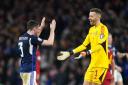 Liverpool's Andrew Robertson and Norwich City goalkeeper Angus Gunn celebrate Scotland's 2-0 victory over Spain.