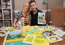 Matt Whitehead, creative director of Patterns of Play, with Tilly Larrington-Spencer, studio manager, and their baby two-month-old Ernie Whitehead, and some of the artwork for the front covers of OTBC programmes. Picture: DENISE BRADLEY