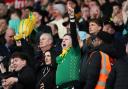 Norwich City fans celebrate their side scoring against Stoke