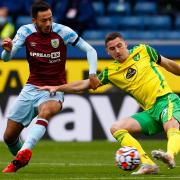 Dwight McNeil of Burnley and Kenny McLean of Norwich in action during the Premier League match at Turf Moor
