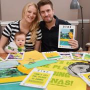 Matt Whitehead, creative director of Patterns of Play, with Tilly Larrington-Spencer, studio manager, and their baby two-month-old Ernie Whitehead, and some of the artwork for the front covers of OTBC programmes. Picture: DENISE BRADLEY