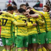 Norwich City players celebrate Ashley Barnes' match-clinching goal in a 3-0 Championship win over Stoke City